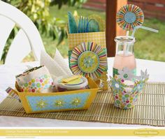 a table topped with vases filled with different types of paper flowers and napkins