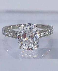 an oval cut diamond ring with pave set shoulders