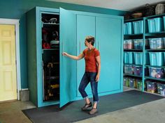 a woman standing in front of a blue locker with several bins on the shelves