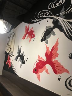 the wall is decorated with fish and waves