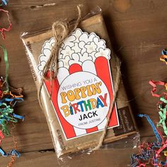 a package of birthday crackers sitting on top of a wooden table next to confetti sprinkles