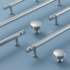 several chrome handles and knobs on a blue background