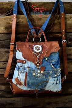 a purse made out of old jeans and other items is hanging on a wooden wall