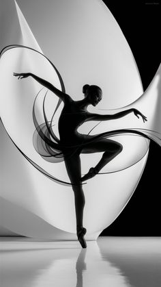 a black and white photo of a ballerina in front of a circular object with her arms stretched out