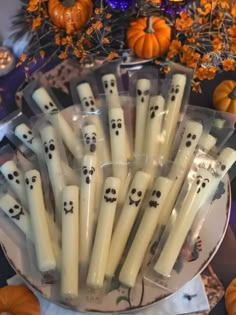 halloween candles with faces on them in a bowl