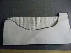 a piece of white paper sitting on top of a wooden table