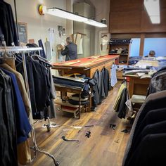 a room filled with lots of clothes on top of a hard wood floor