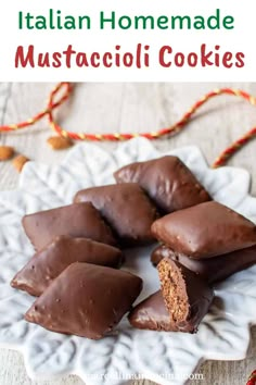 chocolate covered cookies on a white plate with the words italian homemade mustacioli cookies