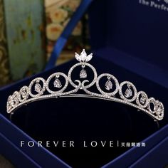 a tiara in a blue box with the words forever love written on it's side