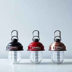 three different types of lights sitting on top of a white table next to each other