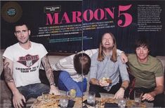 a group of men sitting around a table with food and drinks in front of them