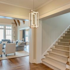 a living room filled with furniture and a stair case