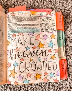 an open book with writing on it and some pens next to it that says make heaven crowded