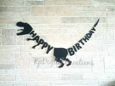 a dinosaur birthday banner on a brick wall with the word happy birthday spelled in black