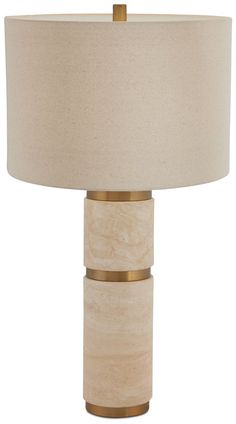 a table lamp with a beige shade on it