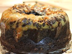 a chocolate bundt cake with caramel toppings on a piece of tin foil