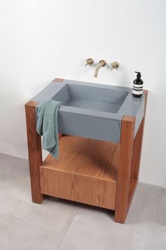 a bathroom sink sitting on top of a wooden shelf