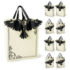 black and white paper bags with birds on the handles are shown in front of each other