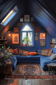 an attic living room with blue walls and lots of pillows on the couches,