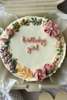 a birthday cake decorated with flowers and the words happy birthday girl written in frosting