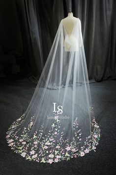 a wedding veil with pink flowers on it