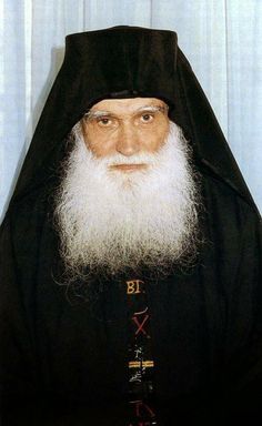 an old man with a long white beard wearing a black robe