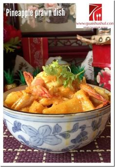 a blue and white bowl filled with food on top of a table