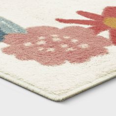 a close up of a piece of cloth with flowers on it and a bird in the middle