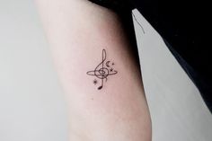 a woman's arm with a small tattoo design on the left side of her arm