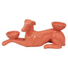 an orange dog figurine with a bowl on its back