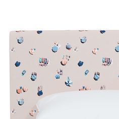 an upholstered bed with pink and blue wallpaper