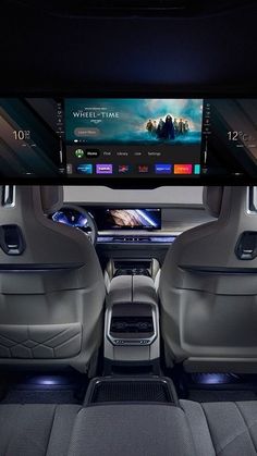 the interior of a car with an entertainment system in the center and seats up to four