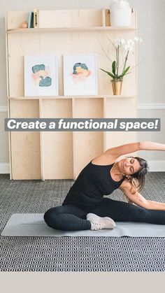 a woman is doing yoga in front of a bookshelf with flowers on it