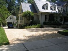 a car parked in front of a large house