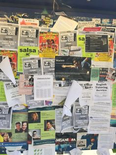 many papers are pinned to the wall with newspaper clippings and other things on them