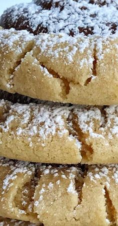 three cookies stacked on top of each other covered in powdered sugar