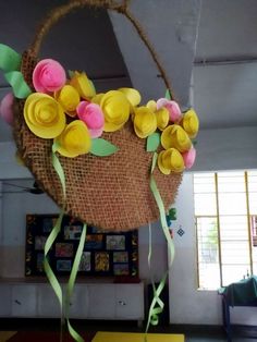 a basket filled with paper flowers on top of a table