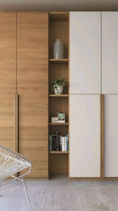 a white chair sitting in front of a wooden cabinet