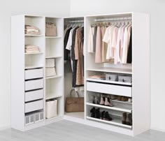 a white closet filled with lots of clothes