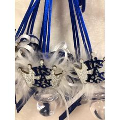 some blue and white hair clips hanging from a hook on a wall ornament