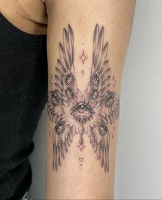 a woman's arm with an eagle tattoo on the left side of her body