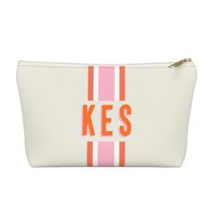 a white and pink cosmetic bag with the word kes printed on it's side