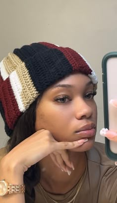 a woman holding up a small toothbrush in front of her face