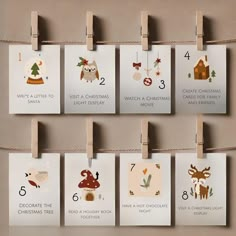 a set of six christmas cards hanging from clothes pegs on a wall next to each other