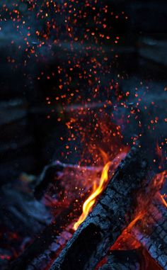 the fire is blazing and it looks like it has been made out of wood or logs