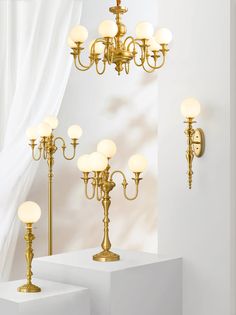 a chandelier that is sitting on some white pedestals