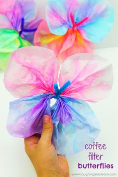 coffee filter butterfly craft for kids to make with tissue paper and colored tissue flowers on the side