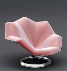 a pink chair sitting on top of a metal stand with a black ring around it