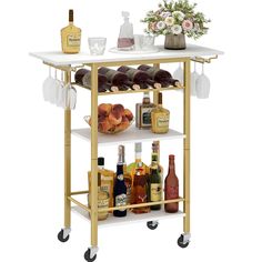 a bar cart with bottles and glasses on it's wheels, filled with drinks