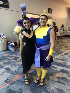 two people dressed in costumes posing for a photo